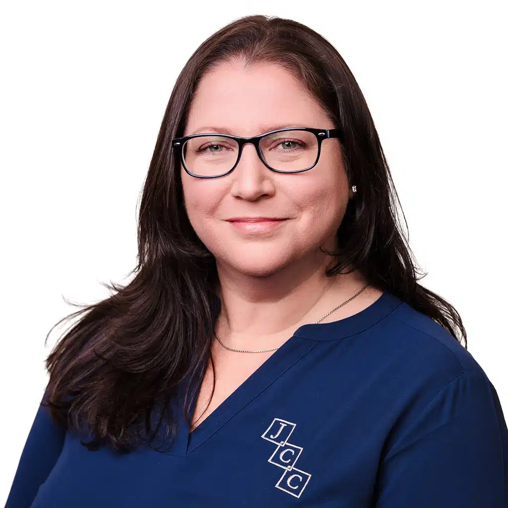 Headshot of Bridget Joyner, a bookkeeping and payroll specialist at Jones, Covey, and Company in Washington, NC. Bridget assists local businesses with detailed financial recordkeeping and accurate payroll management. She is smiling in a navy blue top with the firm's logo against a white background.